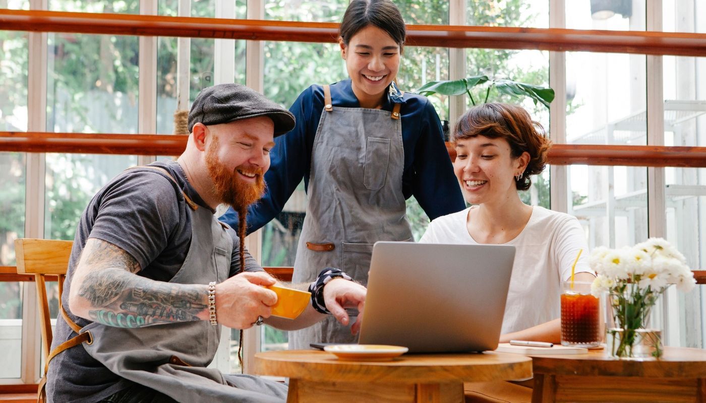 Business owner and staff members communicating, demonstrating the skills of a successful franchise owner