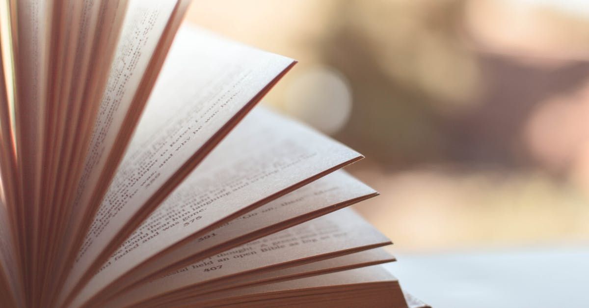 A close up of an open book on a table.