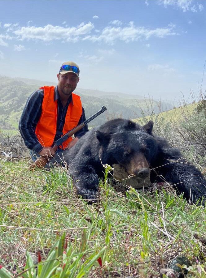 A man with a black bear.