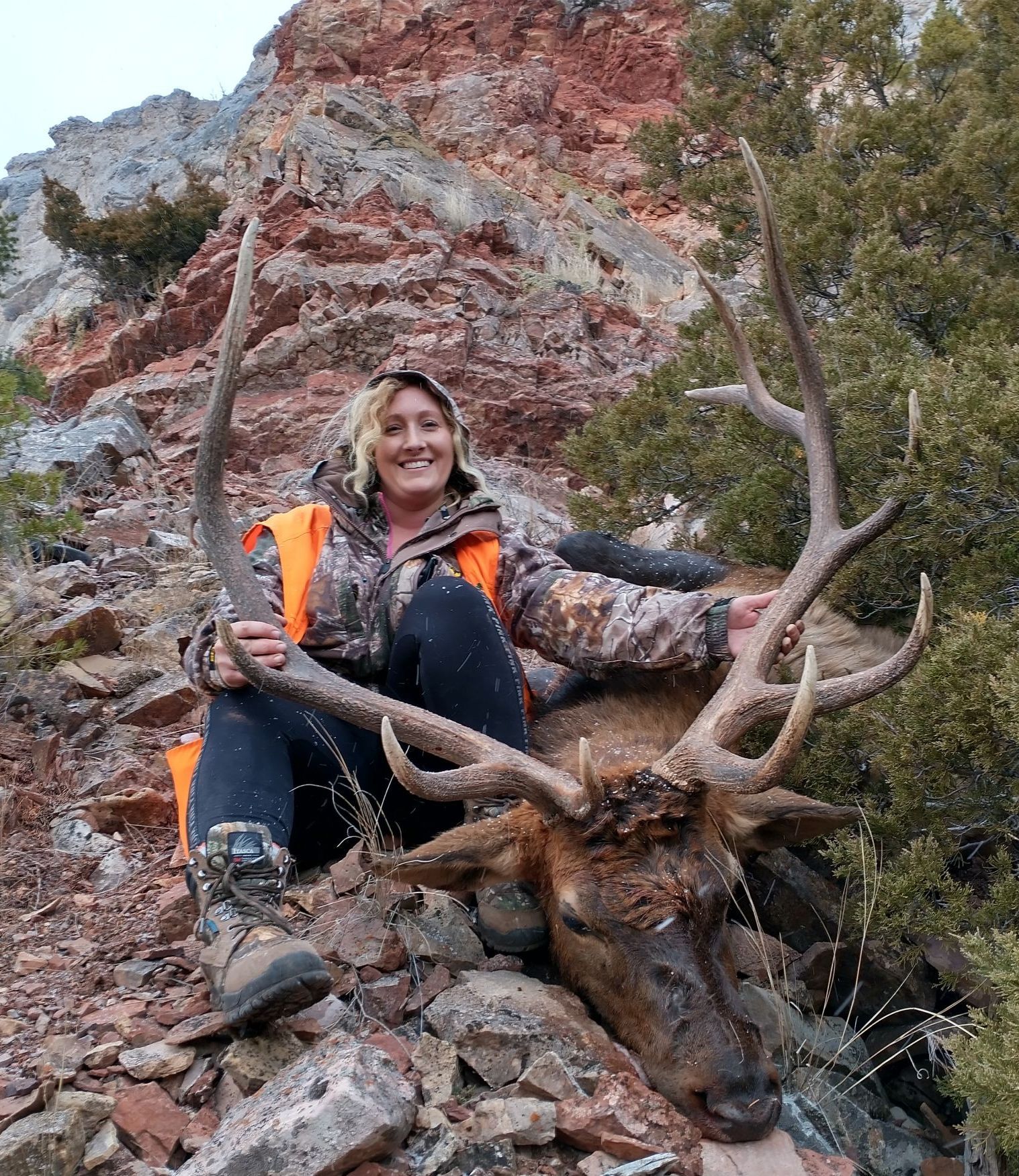 A woman holding a big elk.