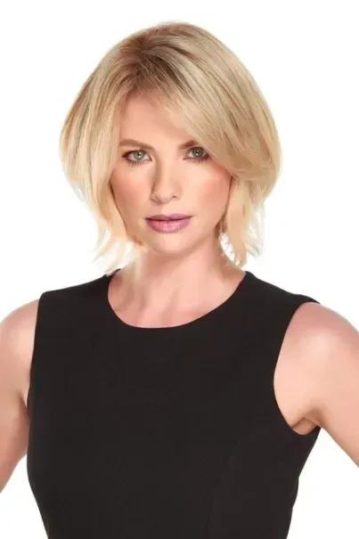 Blonde woman in a sleeveless black top against a white background