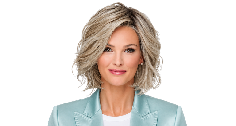Portrait of a smiling woman in a light blue blazer against a white background