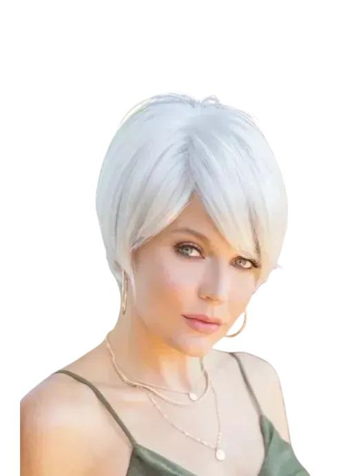 Portrait of a person with short white hair, gold hoop earrings, and layered necklaces against a plain white background