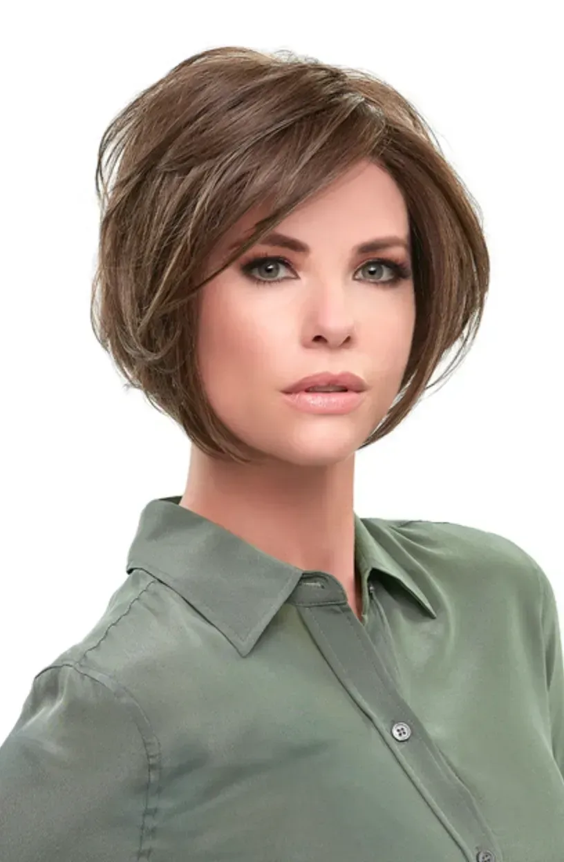 Portrait of a person with short brown hair wearing a light green collared shirt on a white background