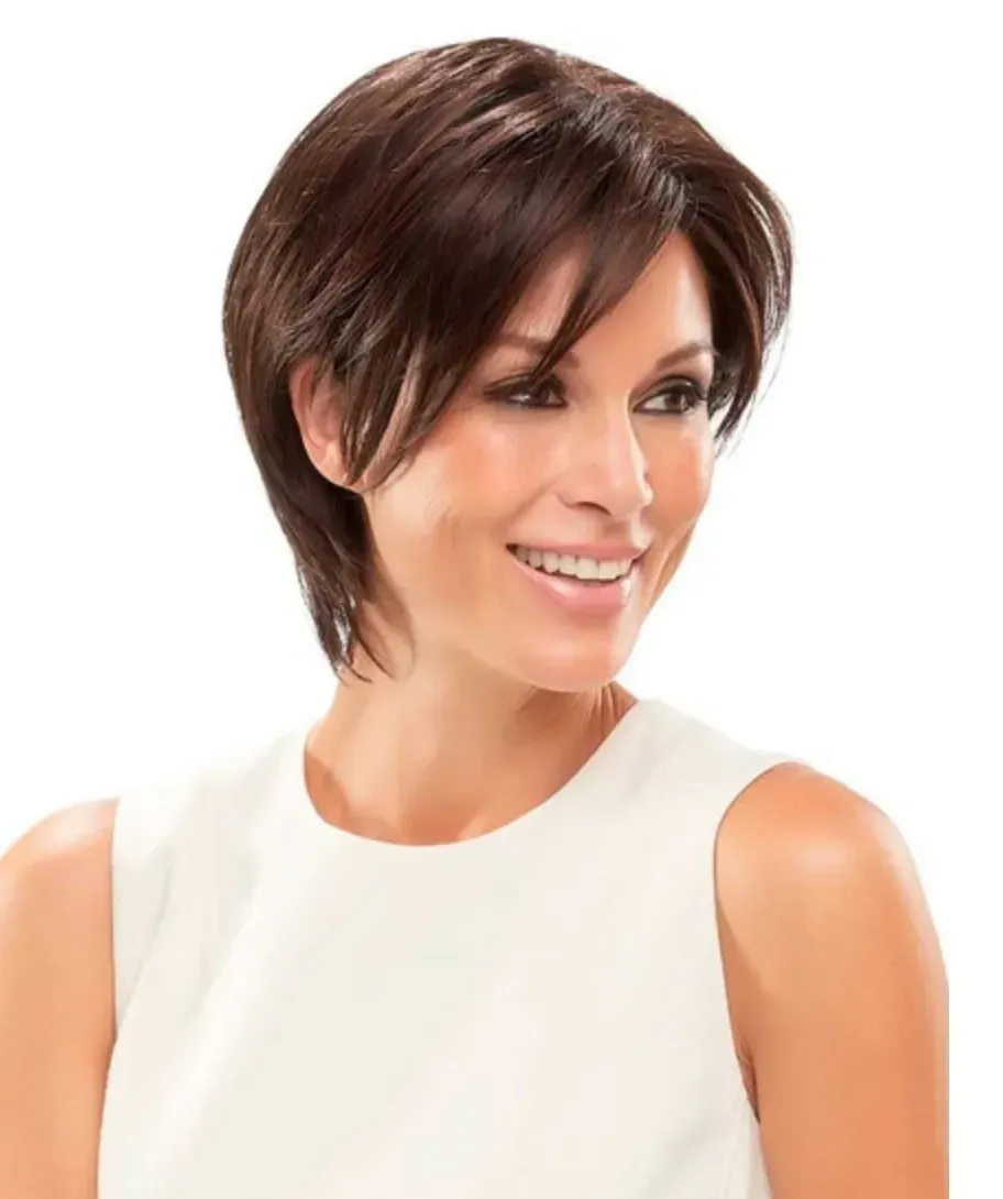 Smiling woman with short brown hair in a white sleeveless top on a white background