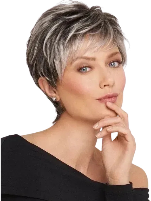 Studio portrait of a short-haired woman in a black top, resting her chin on her hand with a thoughtful expression