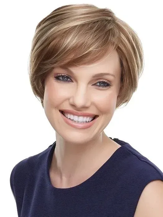 Smiling woman with short blonde hair wearing a navy top on a white background