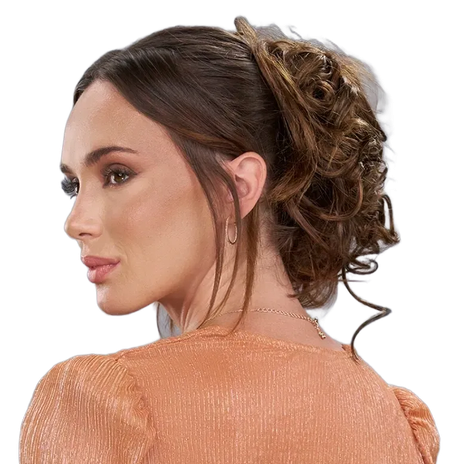 Profile view of a woman with an elegant updo and peach textured top against a white background