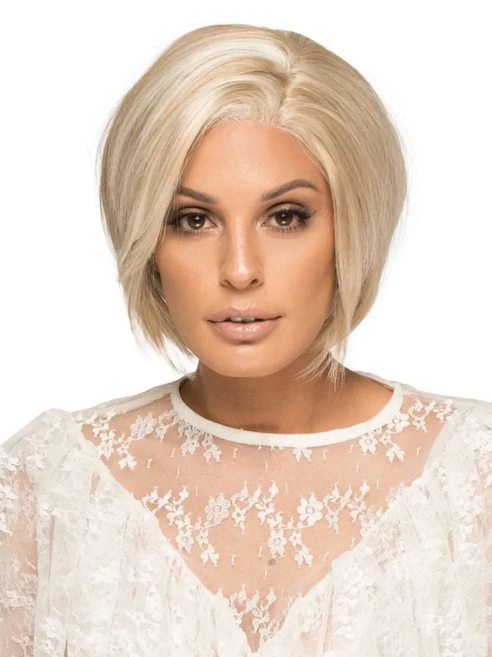 Portrait of a blonde woman in a white lace top against a white background