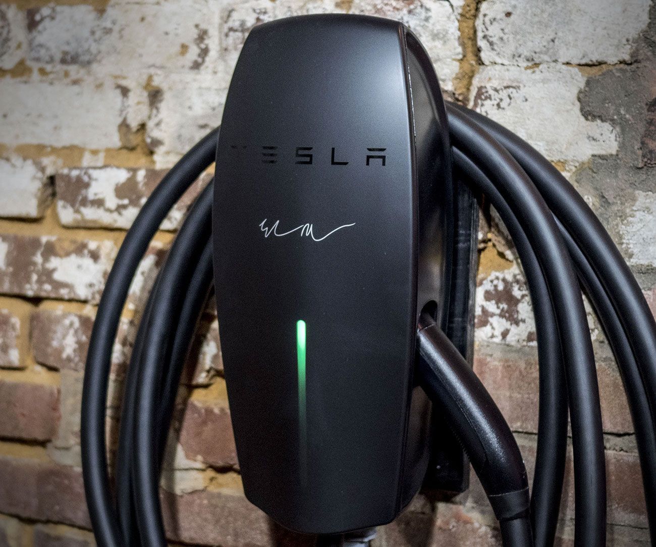 Integrity Energy Systems A tesla charging station is attached to a brick wall