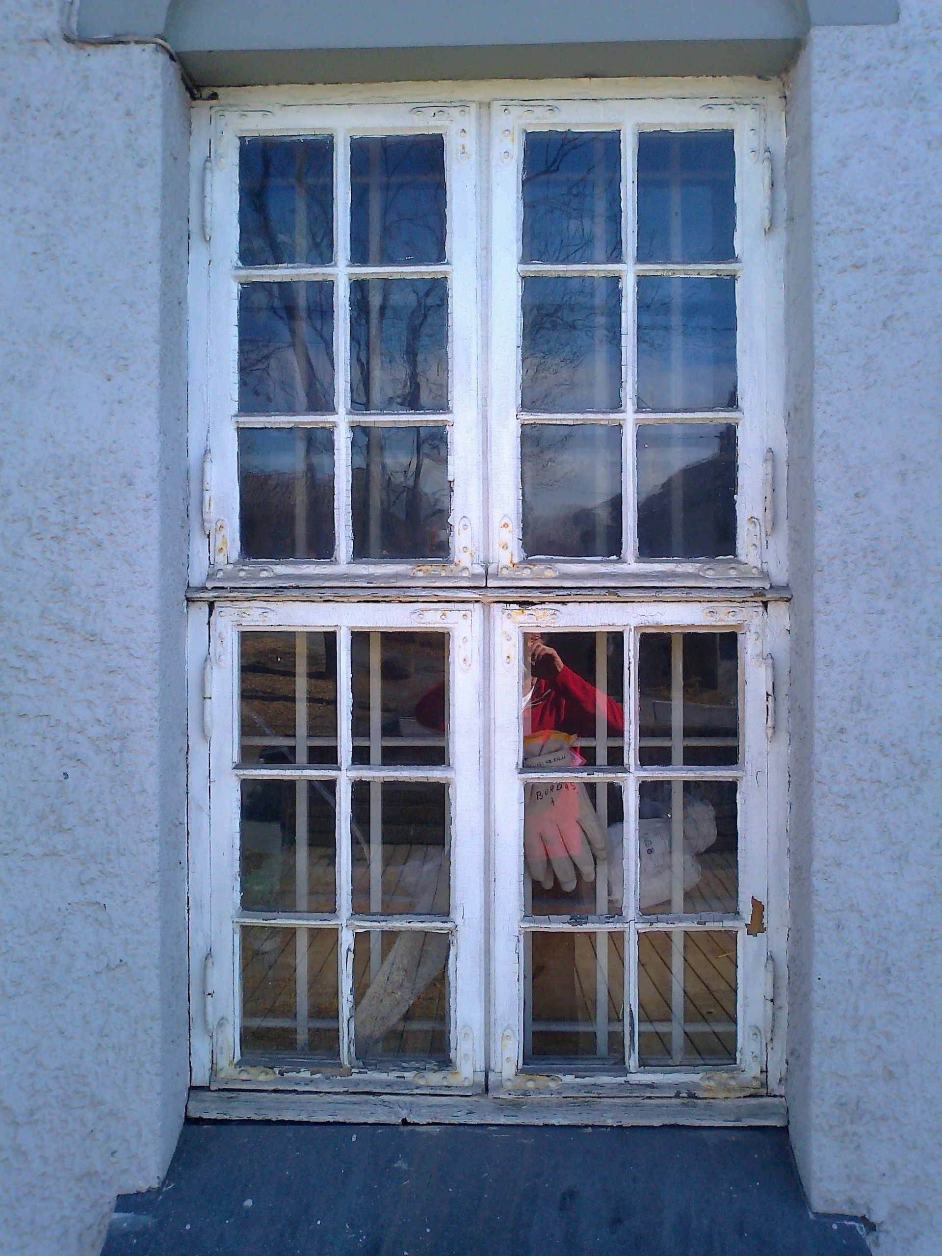 A window with a reflection of a person in it