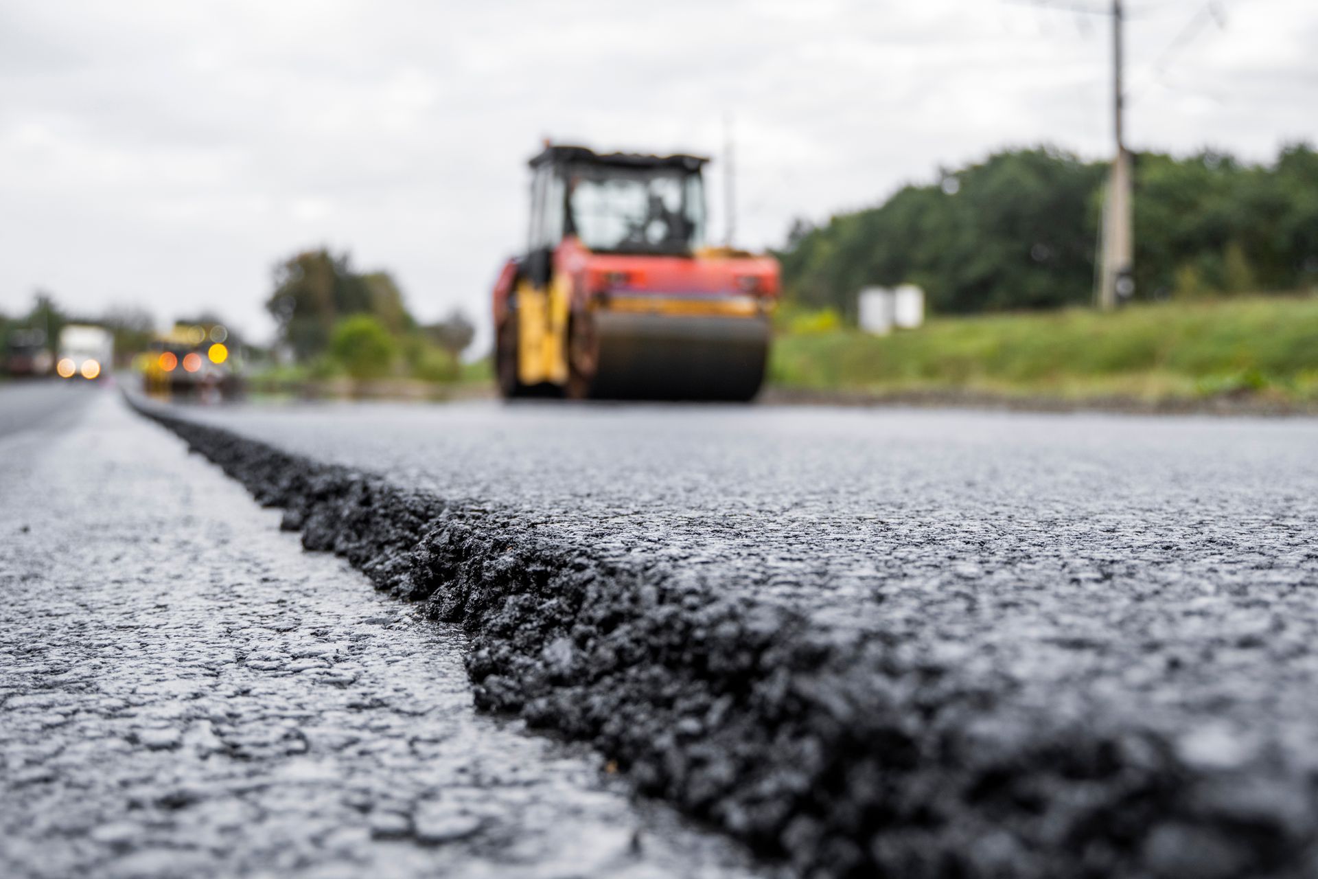 A roller is rolling asphalt on a road.