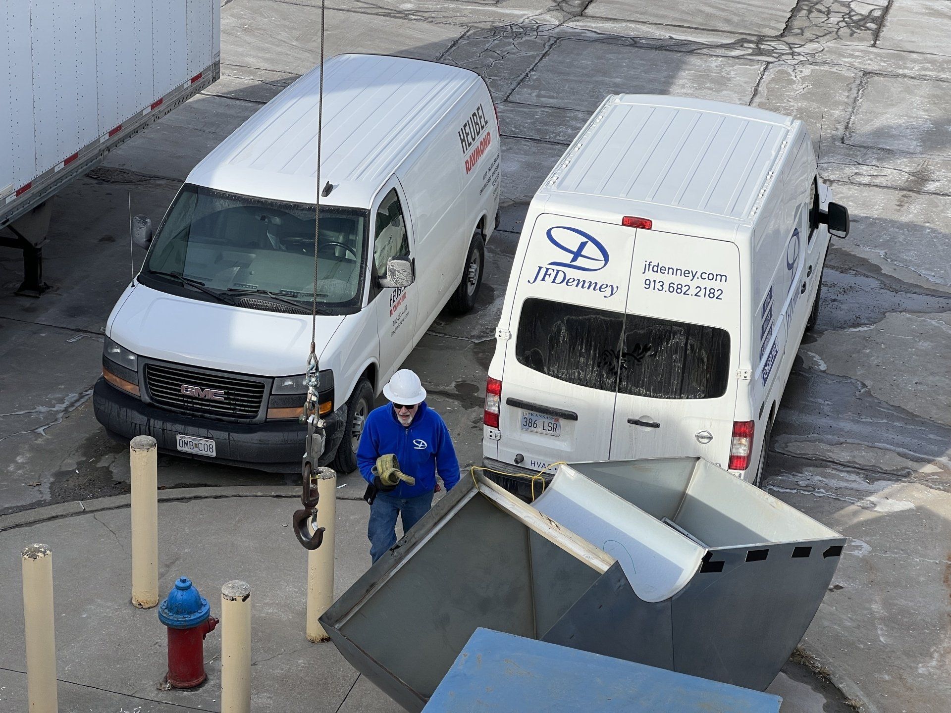 Two gmc vans are parked next to each other