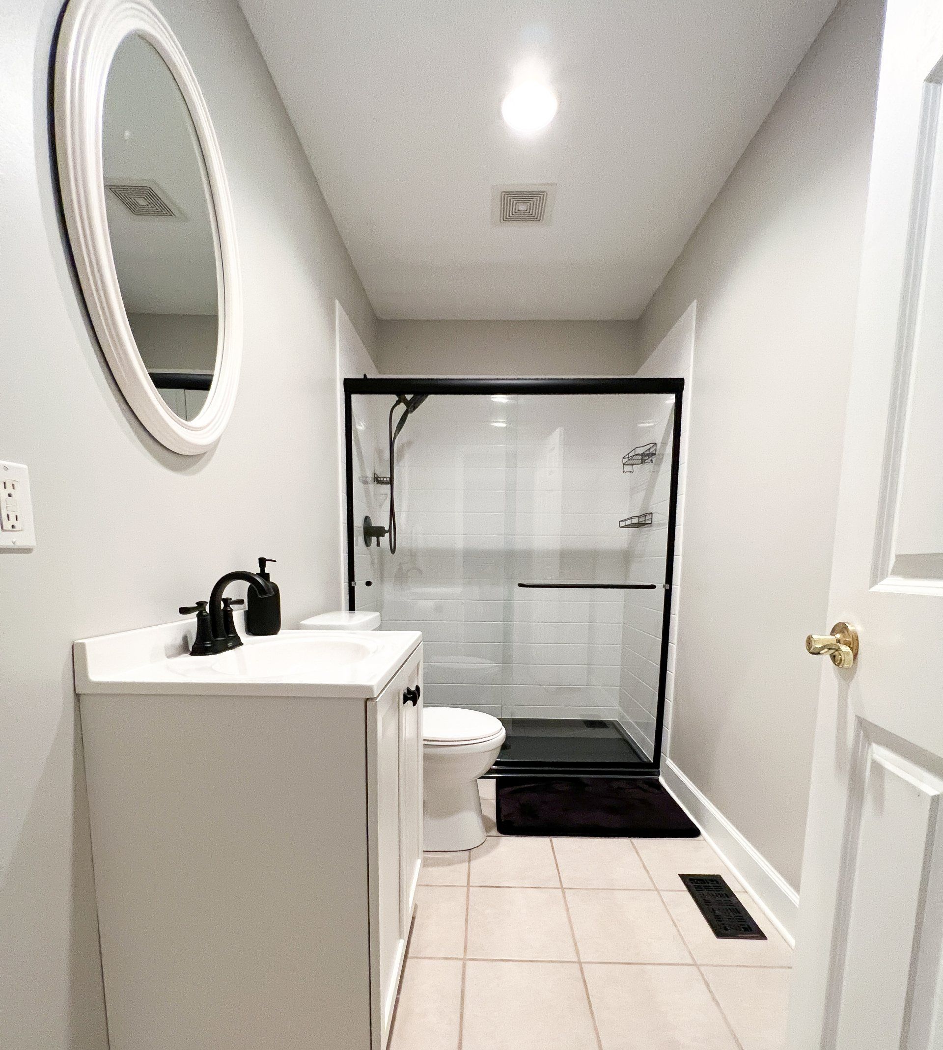 Completed bathroom remodel by J.F. Denney featuring modern fixtures