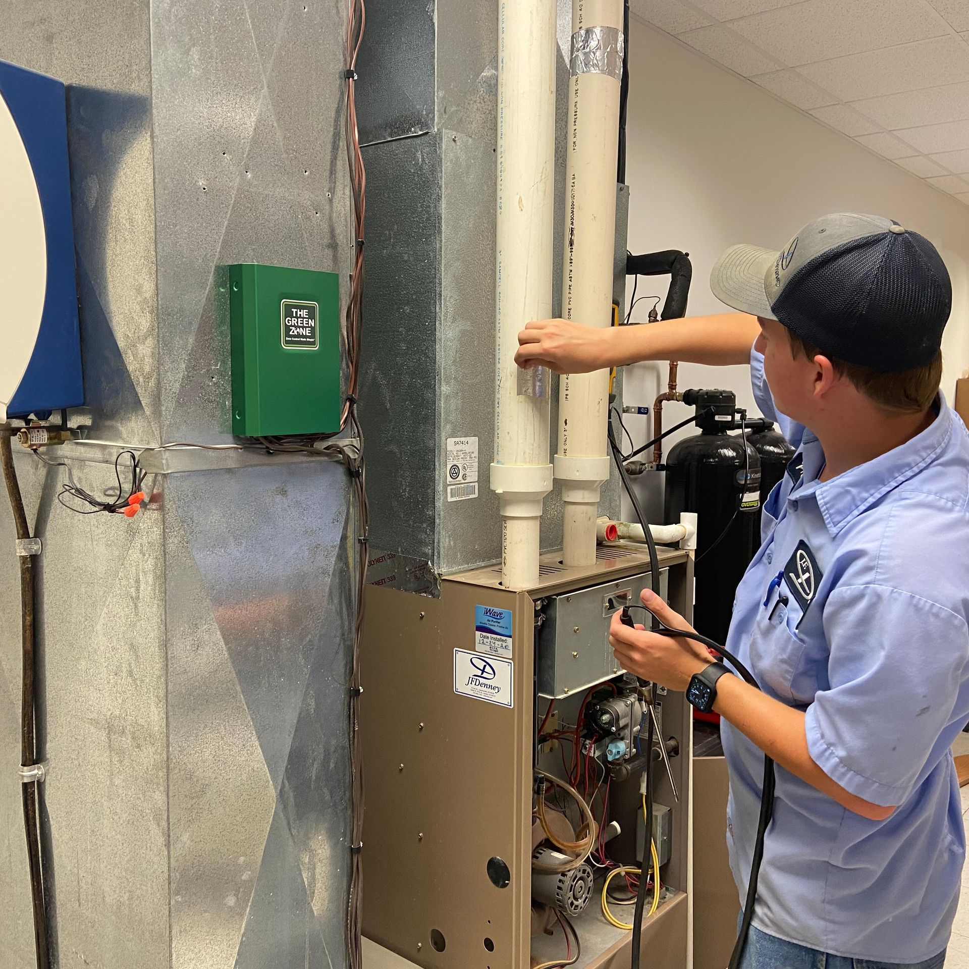 J.F. Denney HVAC technician installing a commercial hood system