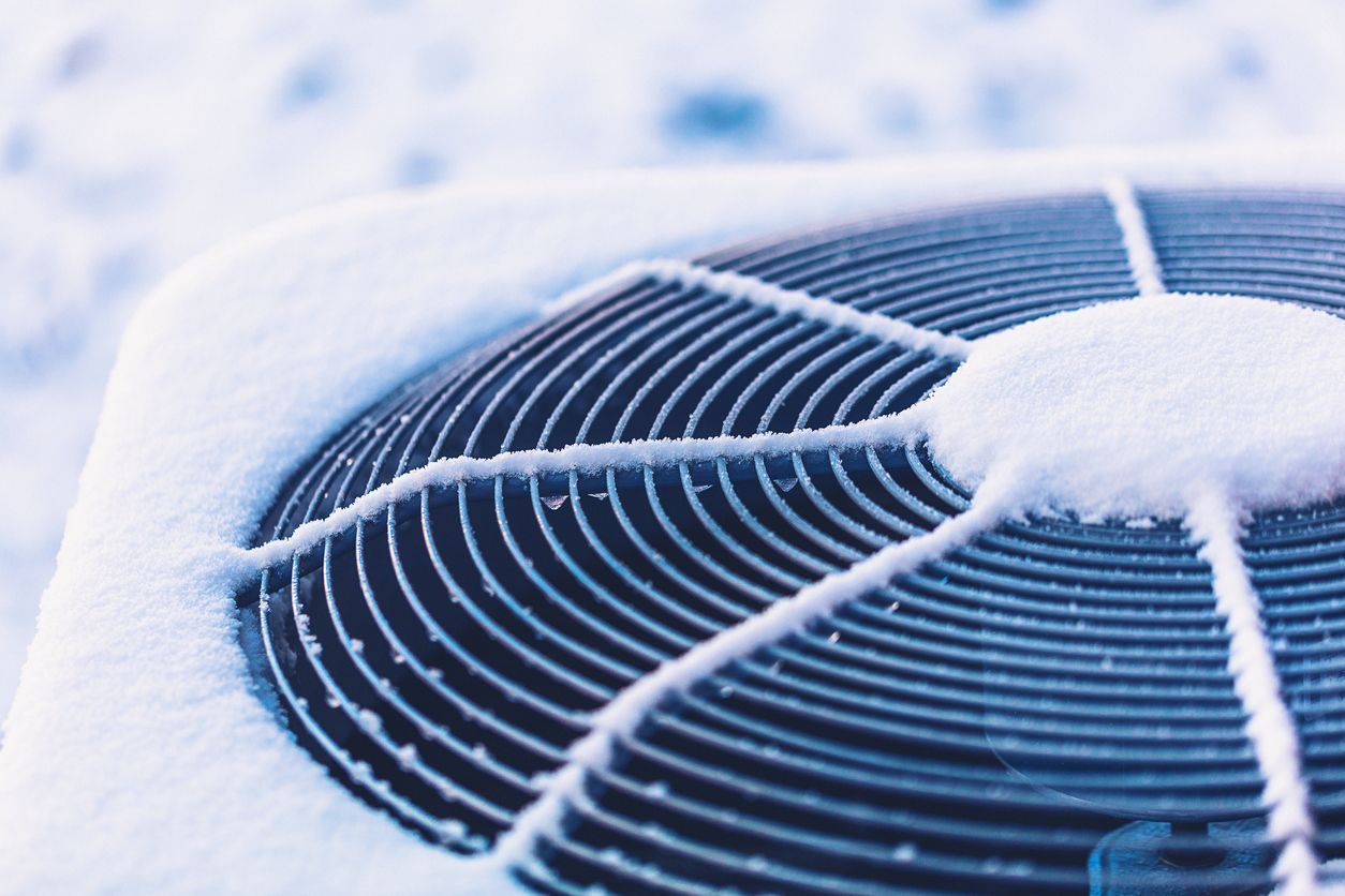 Outdoor HVAC unit covered in snow