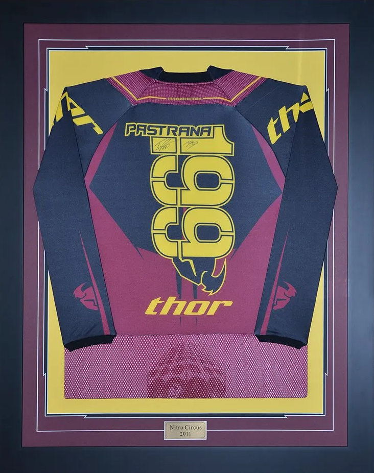 Framed purple-and-yellow motocross jersey with the number 199 and Thor logo