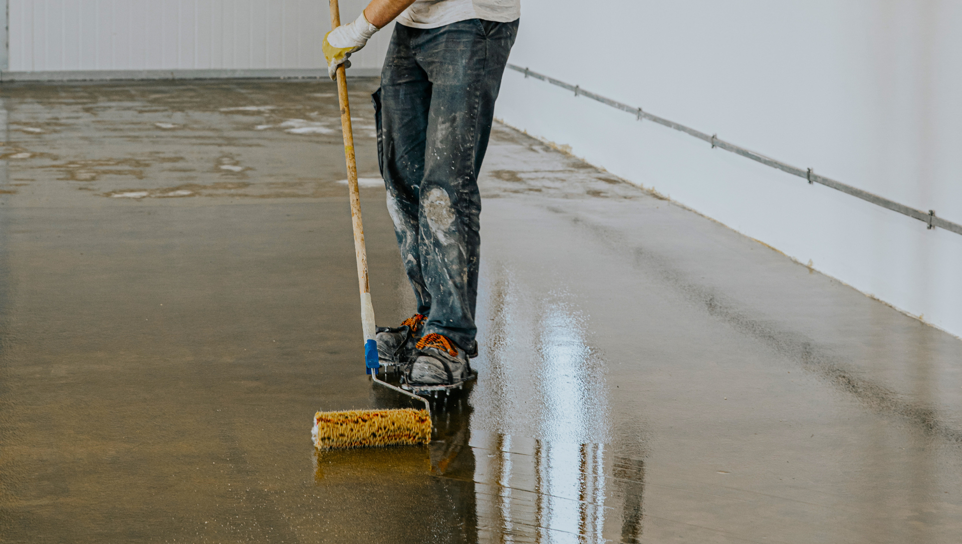 Epoxy expert rolling epoxy on garage floor