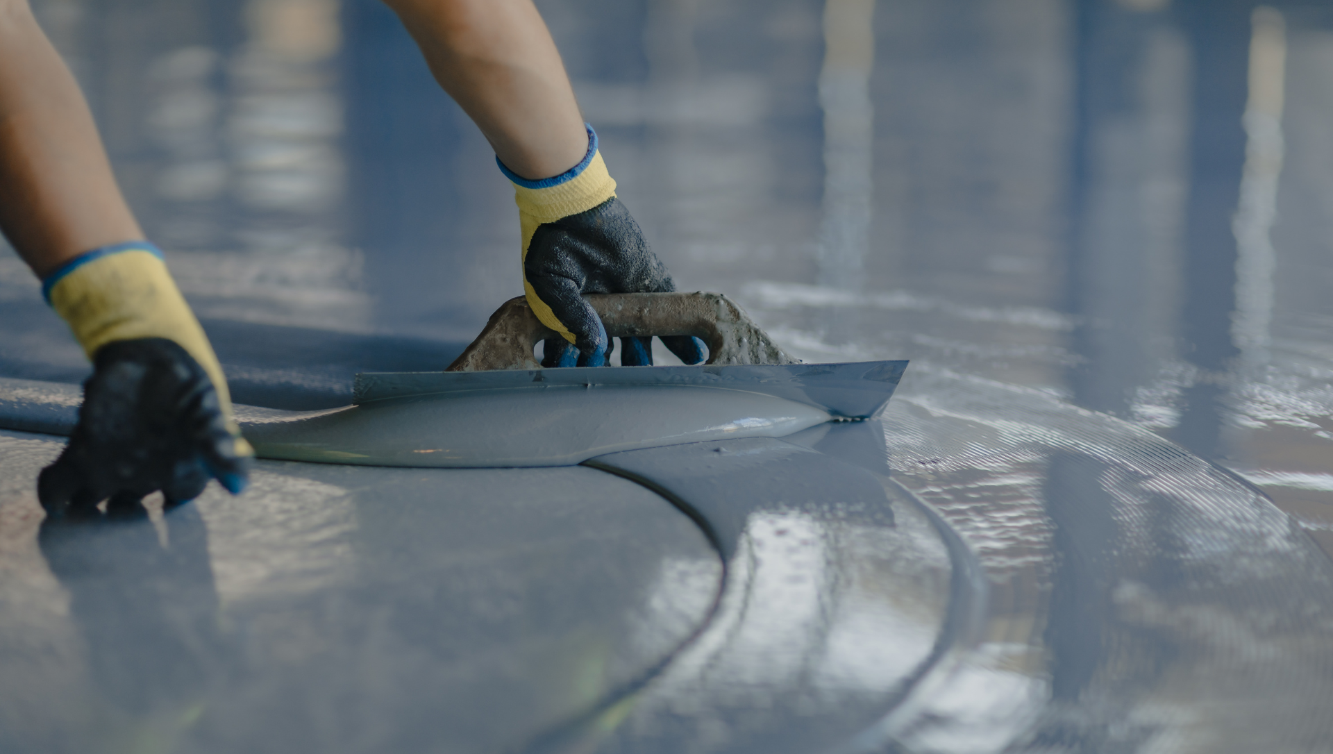 Crew member spreading epoxy coat on floor