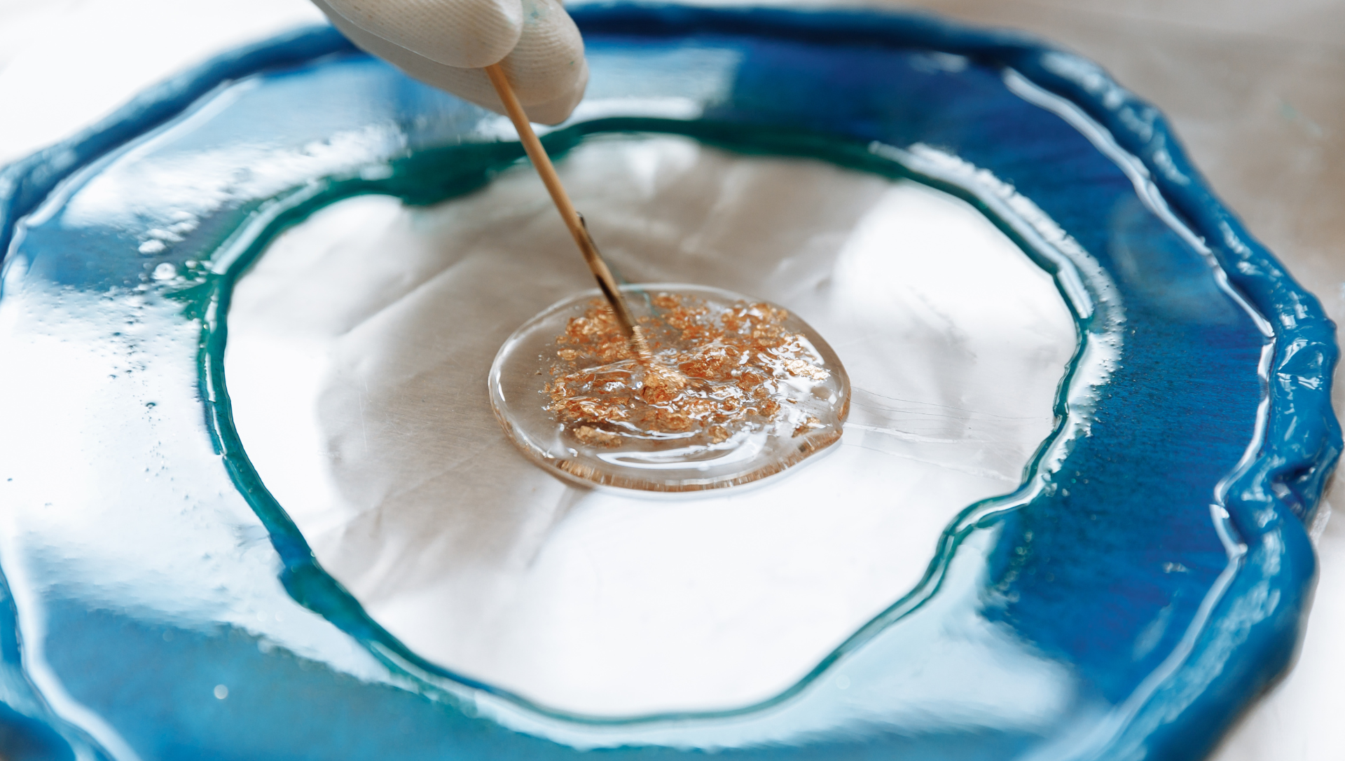 Epoxy expert mixing colors and metallic flakes