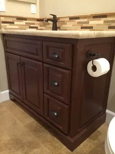 A bathroom vanity with a toilet paper holder and a sink.