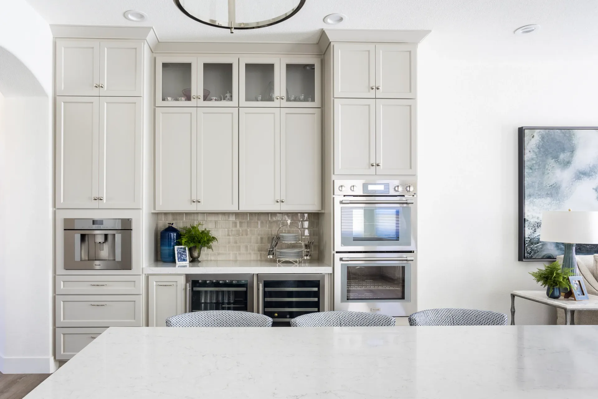 A kitchen with white cabinets and stainless steel appliances.
