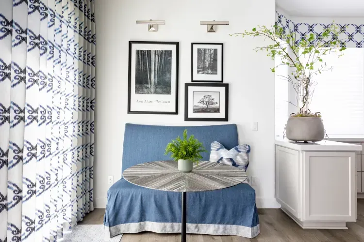 A living room with a blue couch and a table