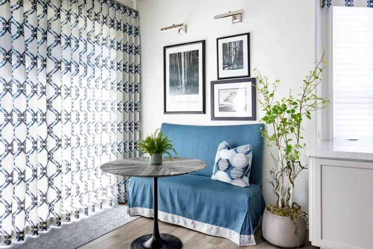 A living room with a blue couch and a table