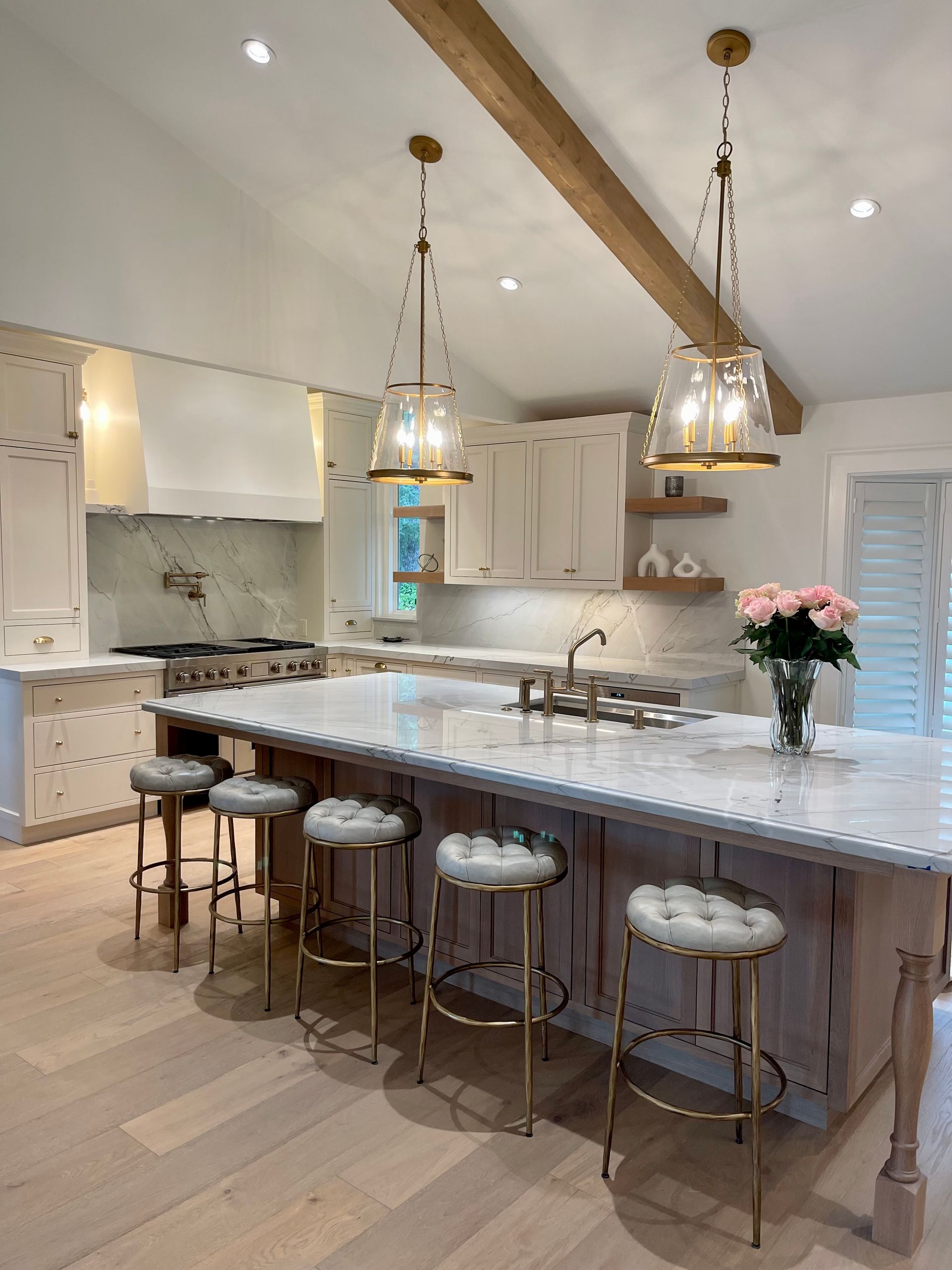 A kitchen with a large island and stools