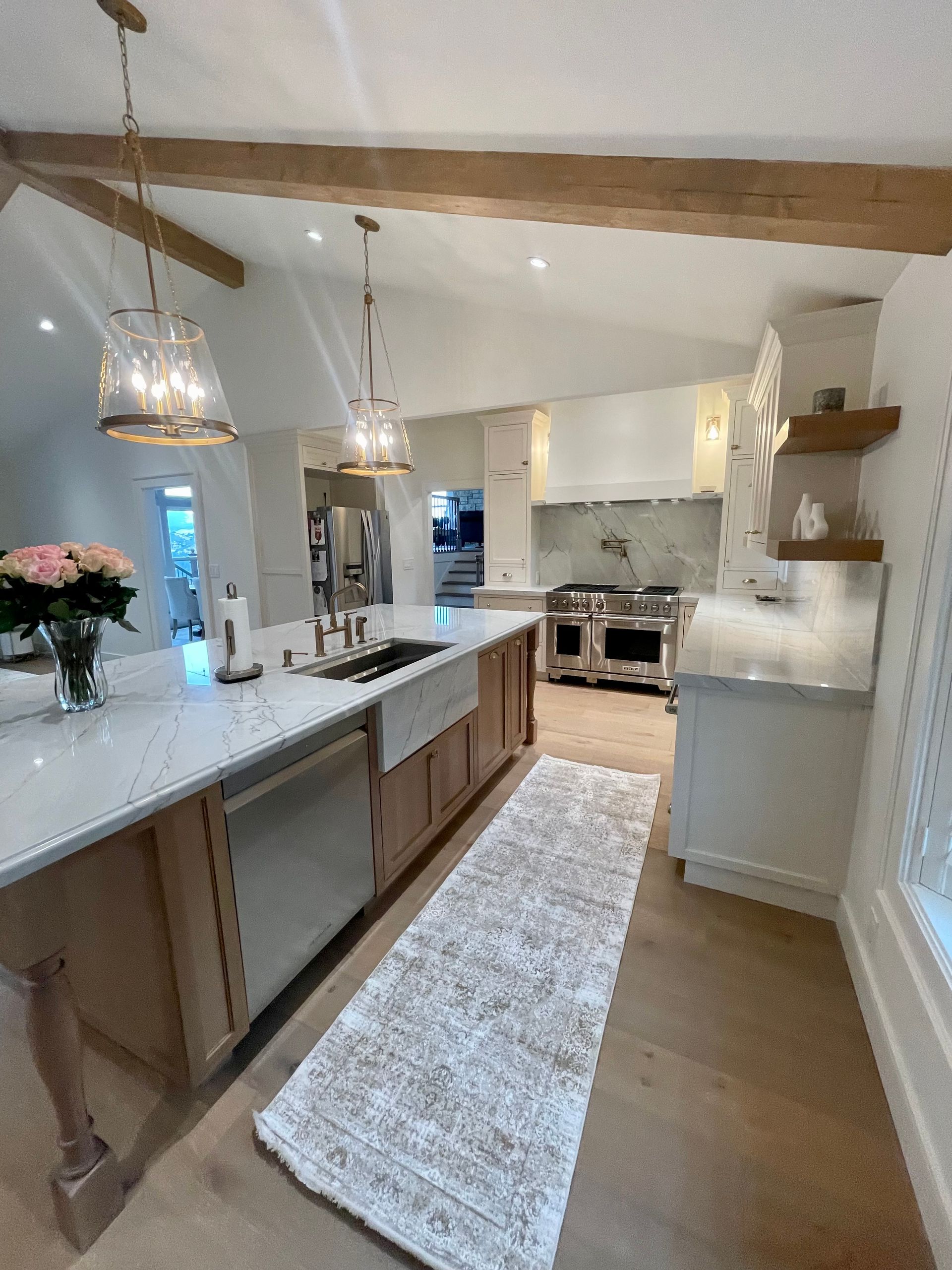 A kitchen with a large island and a rug on the floor