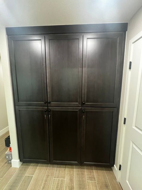A room with a lot of cabinets and a tiled floor.
