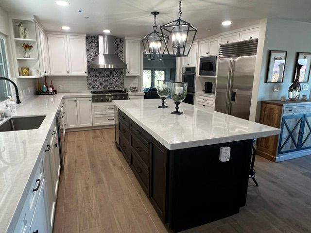 There is a large island in the middle of the kitchen.