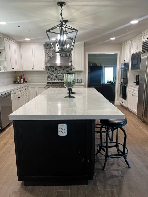 There is a large island in the middle of the kitchen.