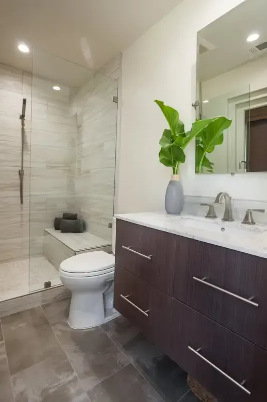 A bathroom with a toilet , sink , and shower.