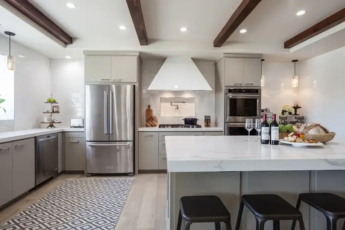 A kitchen with stainless steel appliances and a large island