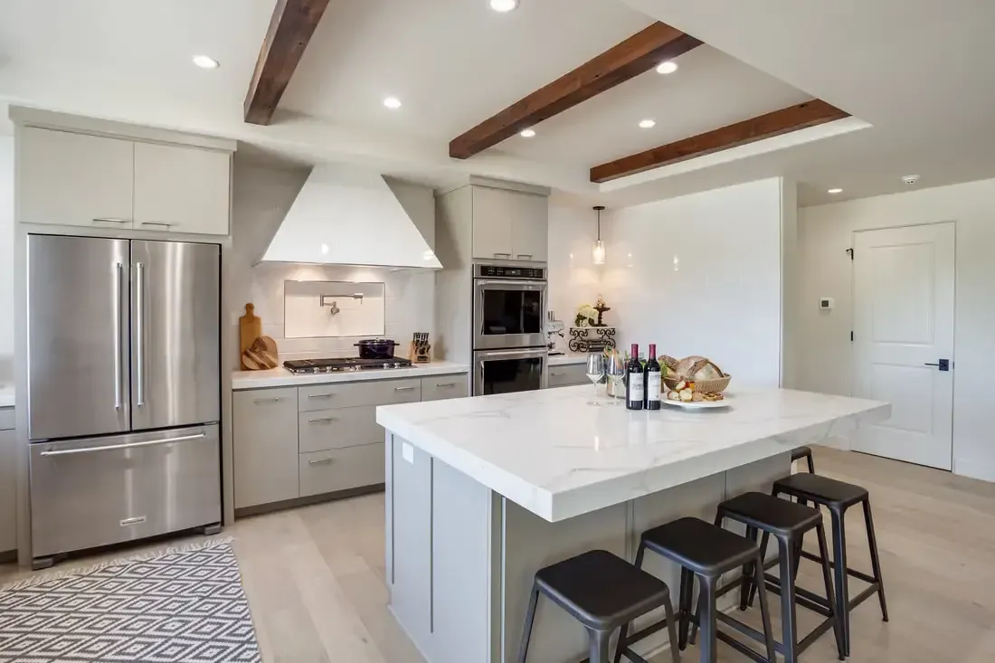 A kitchen with stainless steel appliances and a large island.