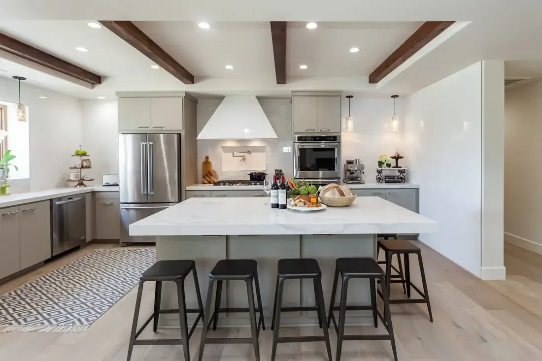 A kitchen with a large island and stools