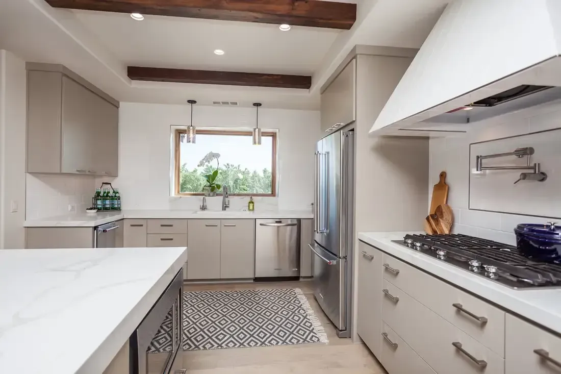 A kitchen with stainless steel appliances and white cabinets