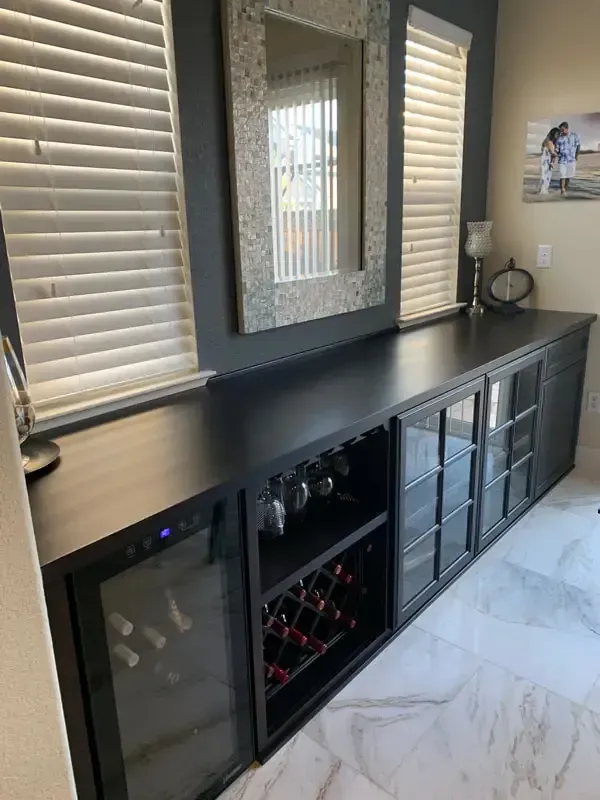 There is a wine cooler in the middle of the room.