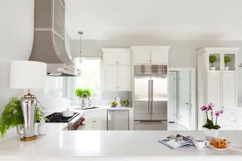 A kitchen with white cabinets and stainless steel appliances