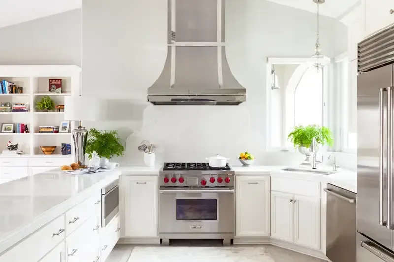 A kitchen with stainless steel appliances and white cabinets