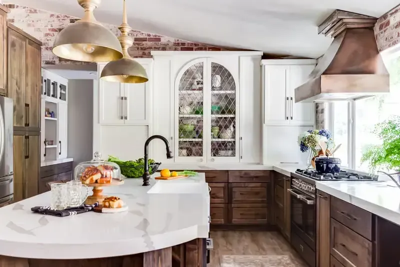 A kitchen with white cabinets , wooden cabinets , stainless steel appliances and a large island.