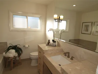 A bathroom with a toilet a sink and a mirror