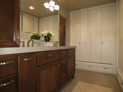A bathroom with two sinks and a large mirror.