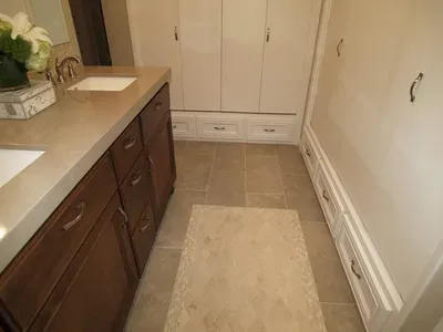 A bathroom with two sinks and a rug on the floor.
