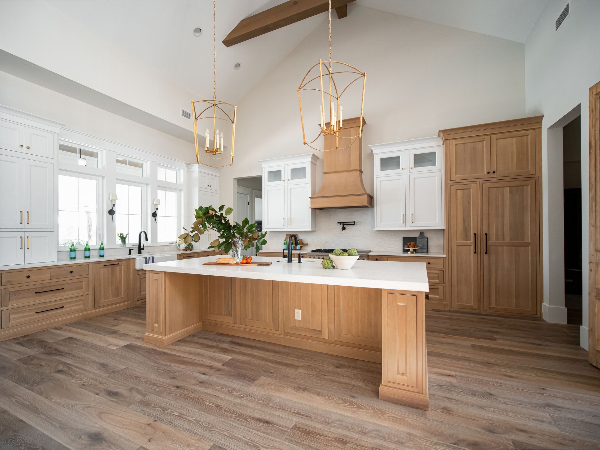A large kitchen with wooden cabinets and a large island.