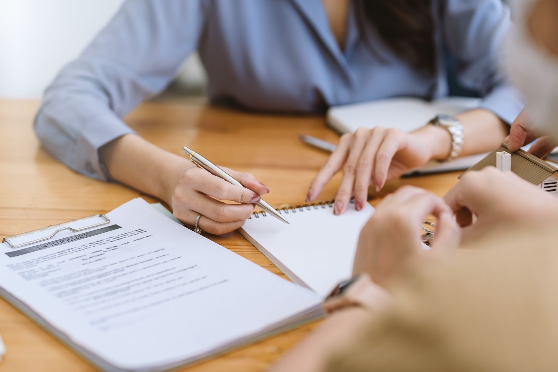 people signing papers at a desk