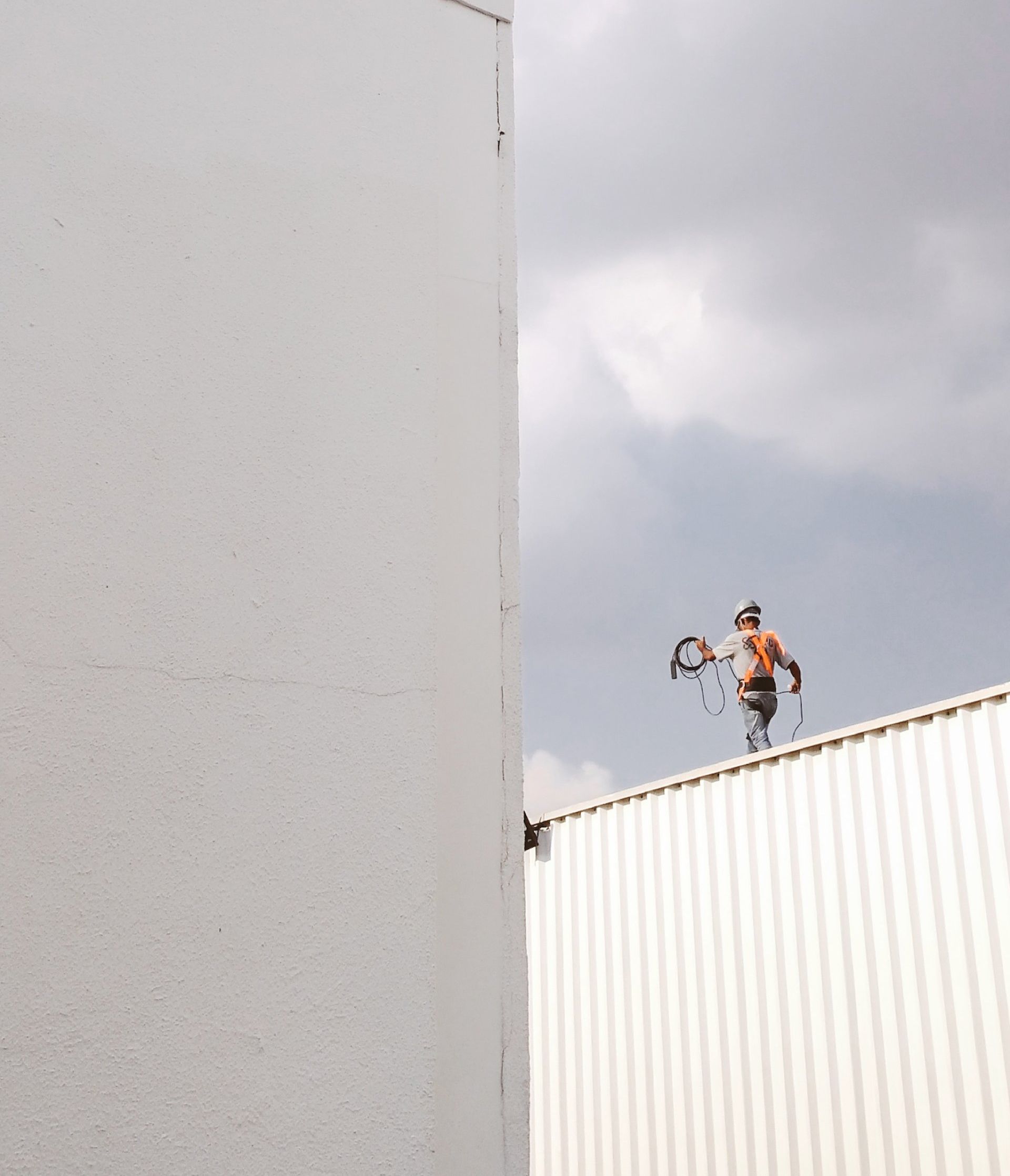 a man is standing on the roof of a building to demonstrate business insurance