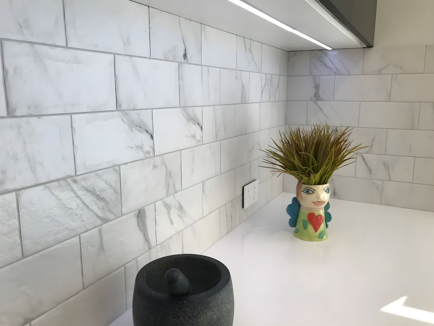 A White Countertop With Marble-patterned Tile Backsplash — North Coast Tiles in Grafton, NSW