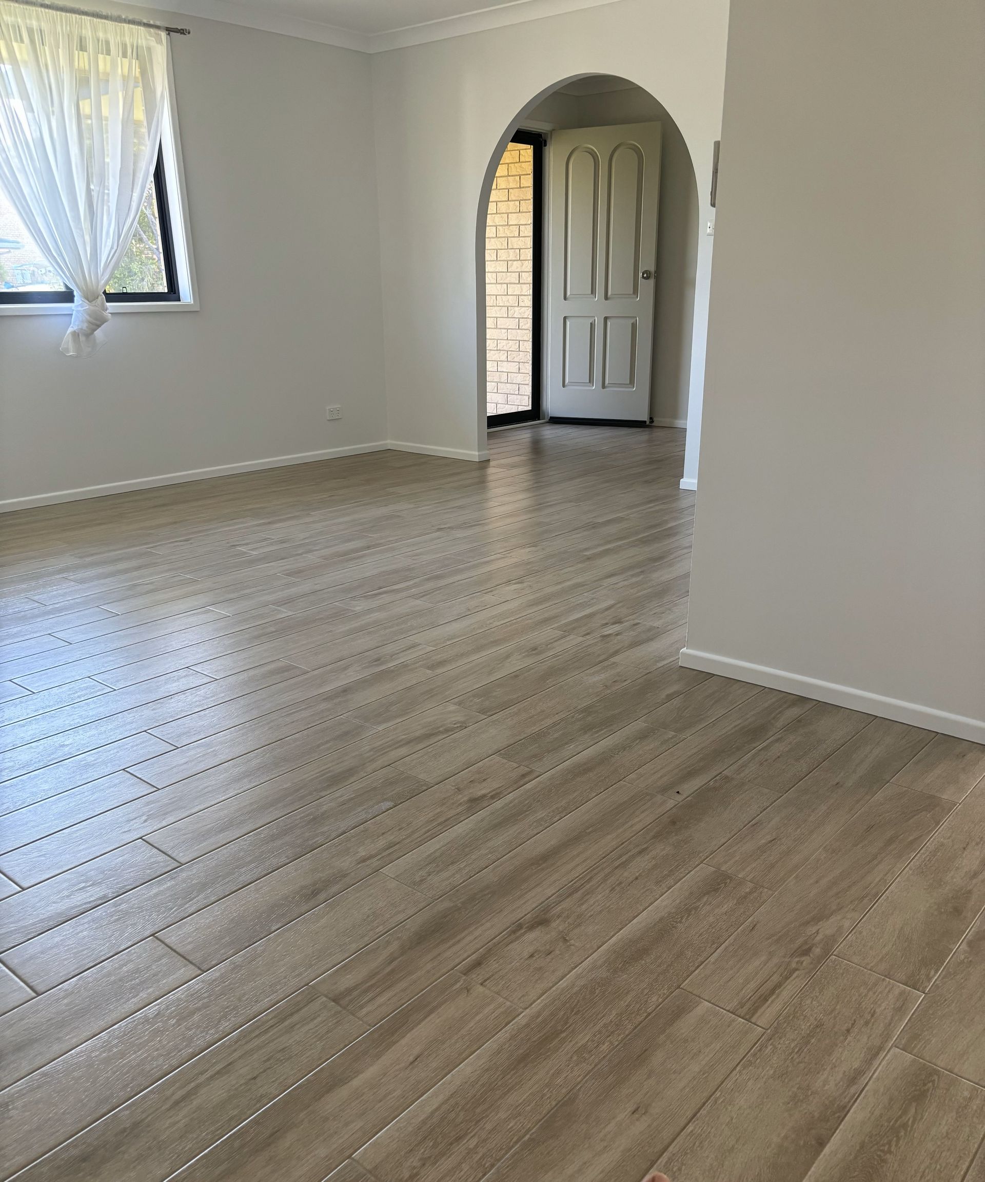 Empty Room With Polished Wooden Floors, a Fireplace, and Display Cabinets — North Coast Tiles in Grafton, NSW